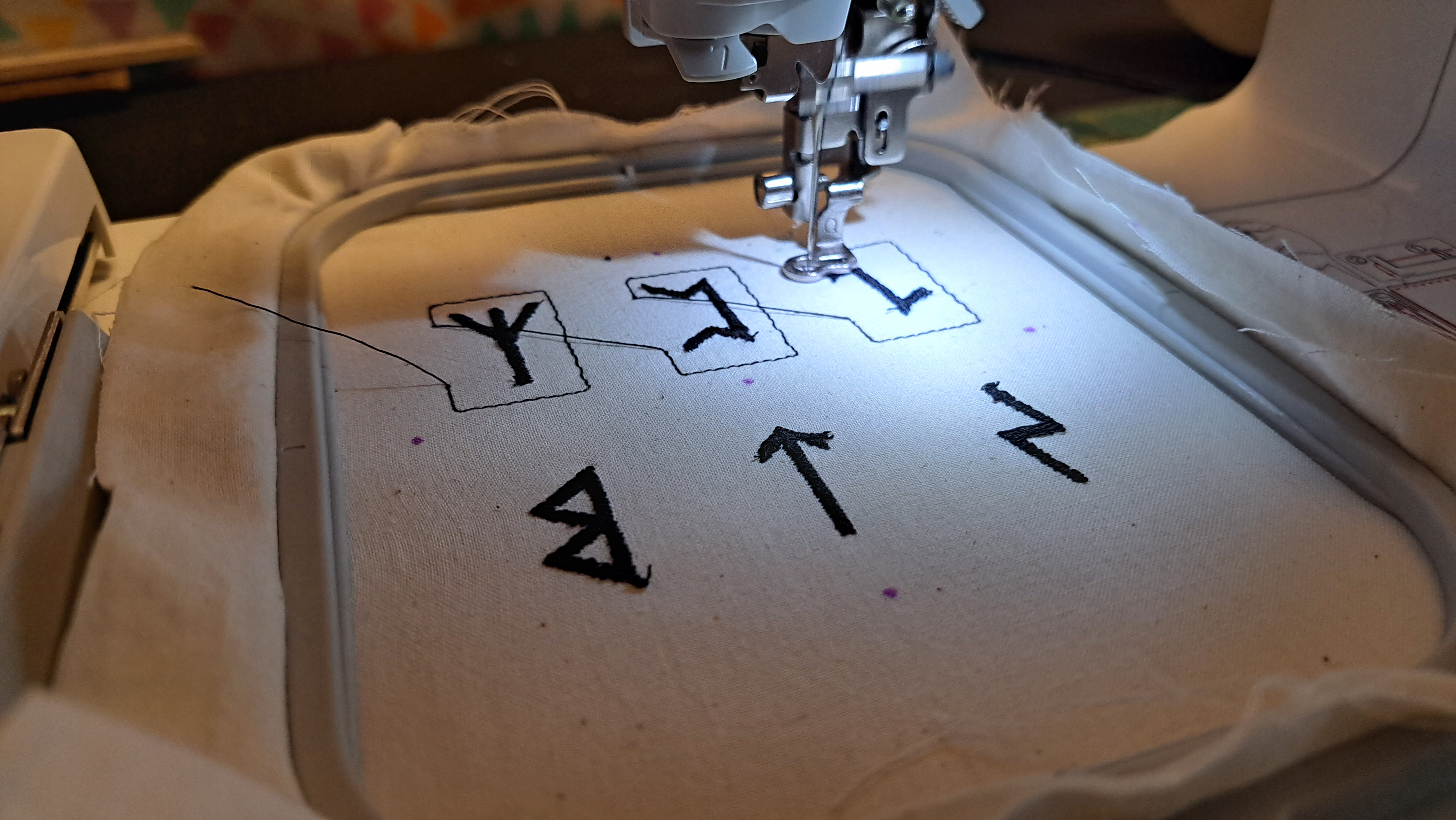 photo of embroidery machine stitching some runes